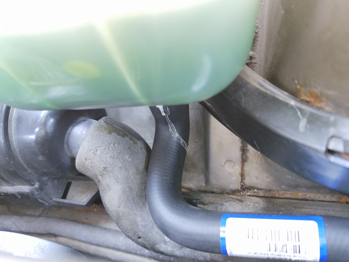 Old coolant tank and new coolant hose and leak