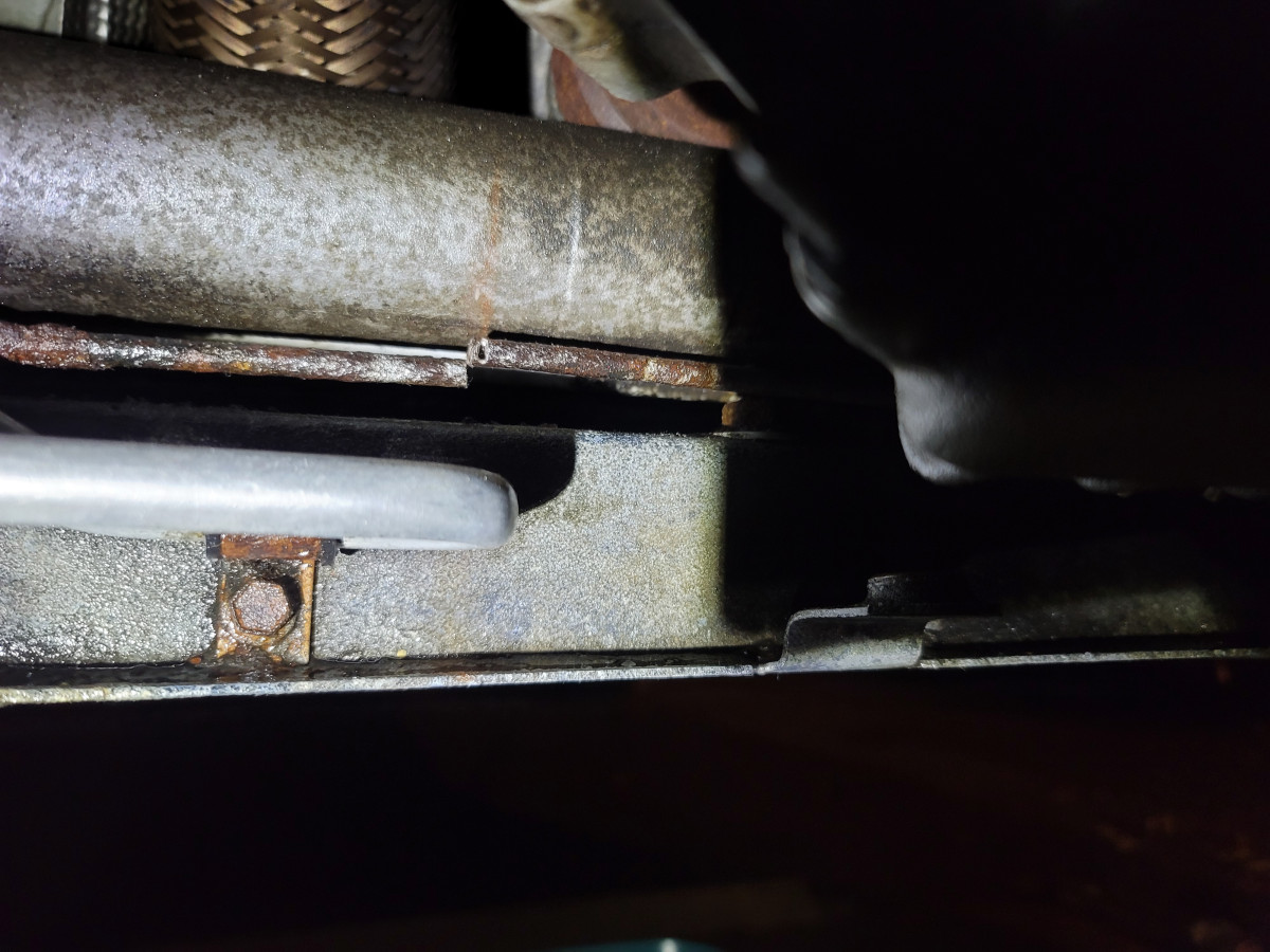 Hydraulic line cut at pinhole leak.