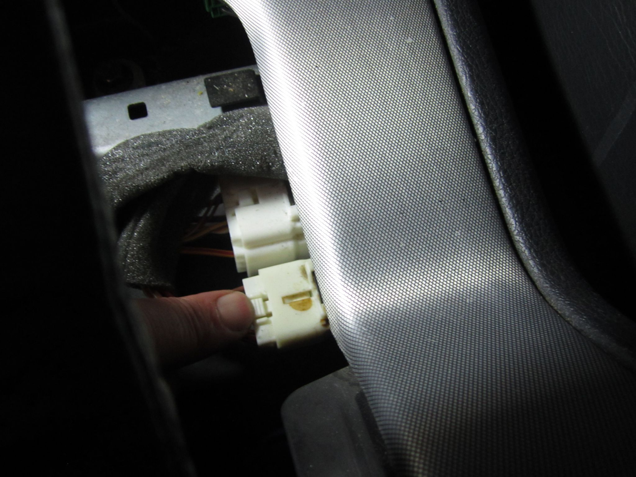 Connectors under parking brake console cover