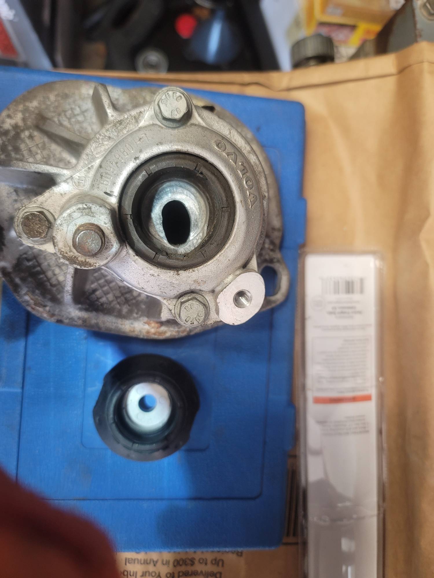 eccentric wear pattern in shock support plate with new part waiting for replacement