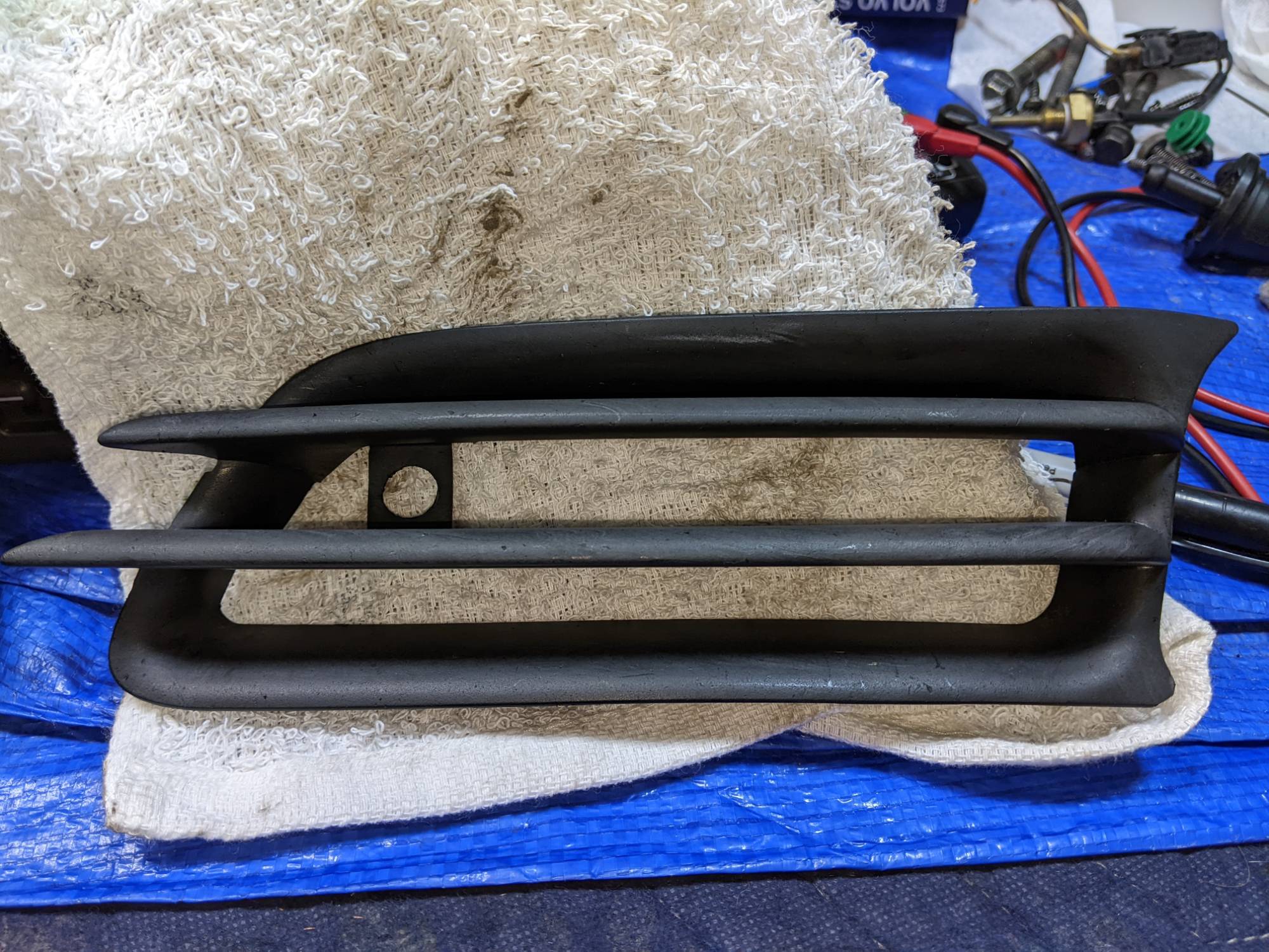 Lower bumper grille beside fog-light - LHS