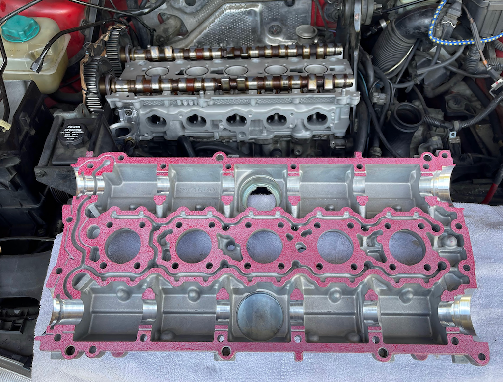 Cam cover with gasket material