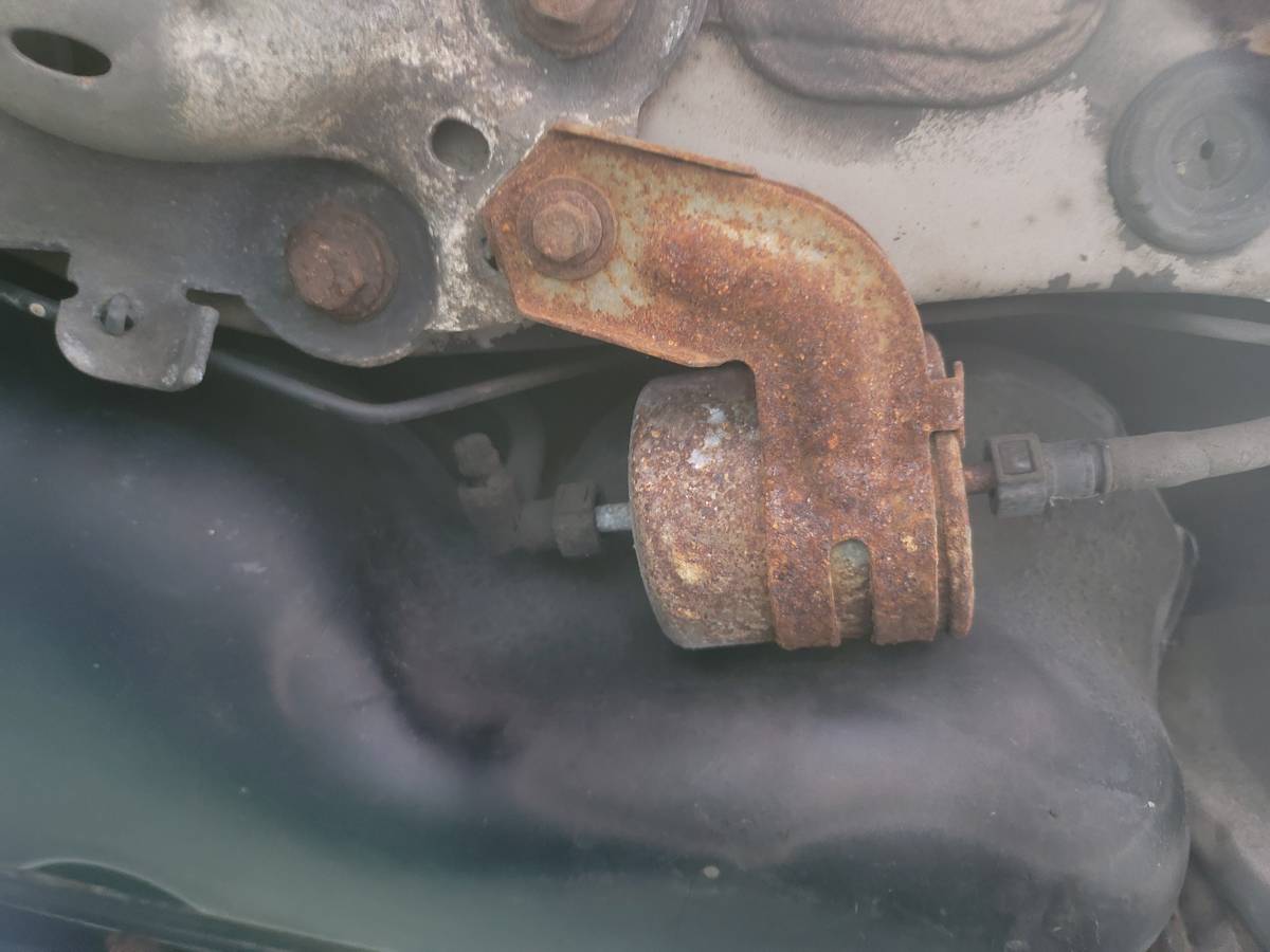 top of gas tank next to fuel filter