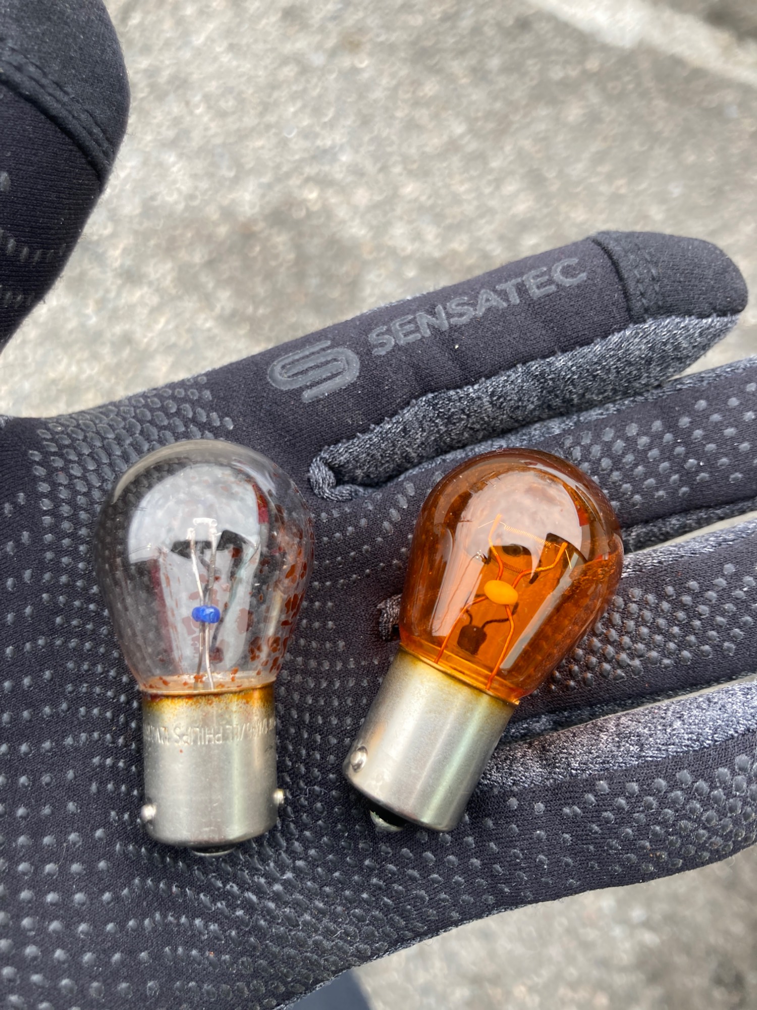 Faded turn signal bulb and a new one.