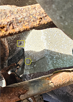 Yellow rectangle and circle outline female fittings for tab and screw of bracket.