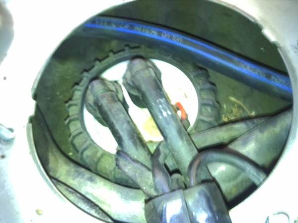 I smell some gas around this area so I am sure this caused fuel smell issue. I don't know what this hose with blue lines is but the cracked hose is under those two skinny hoses