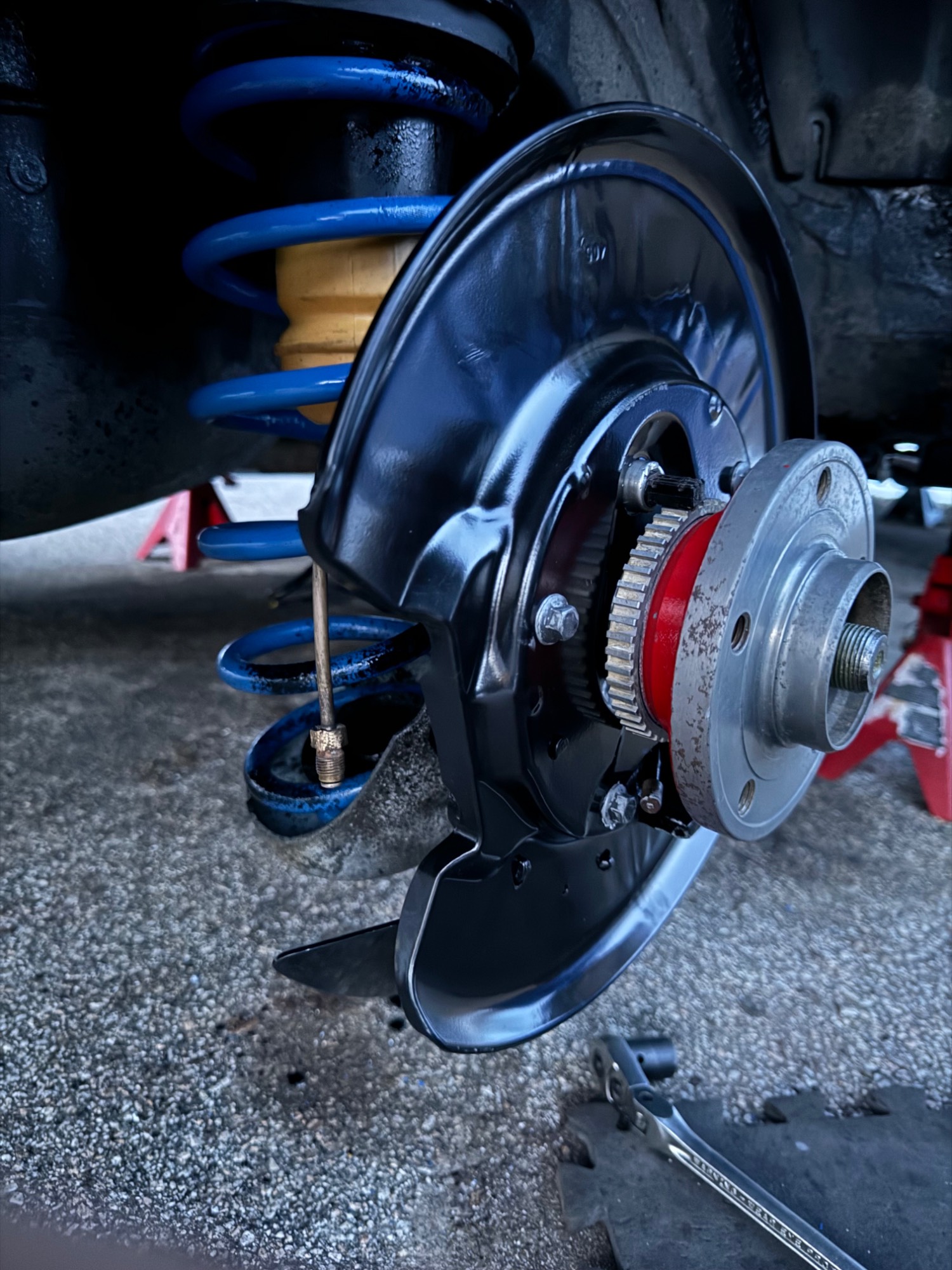 Cheap dust shield on the passenger side has some wrinkling.