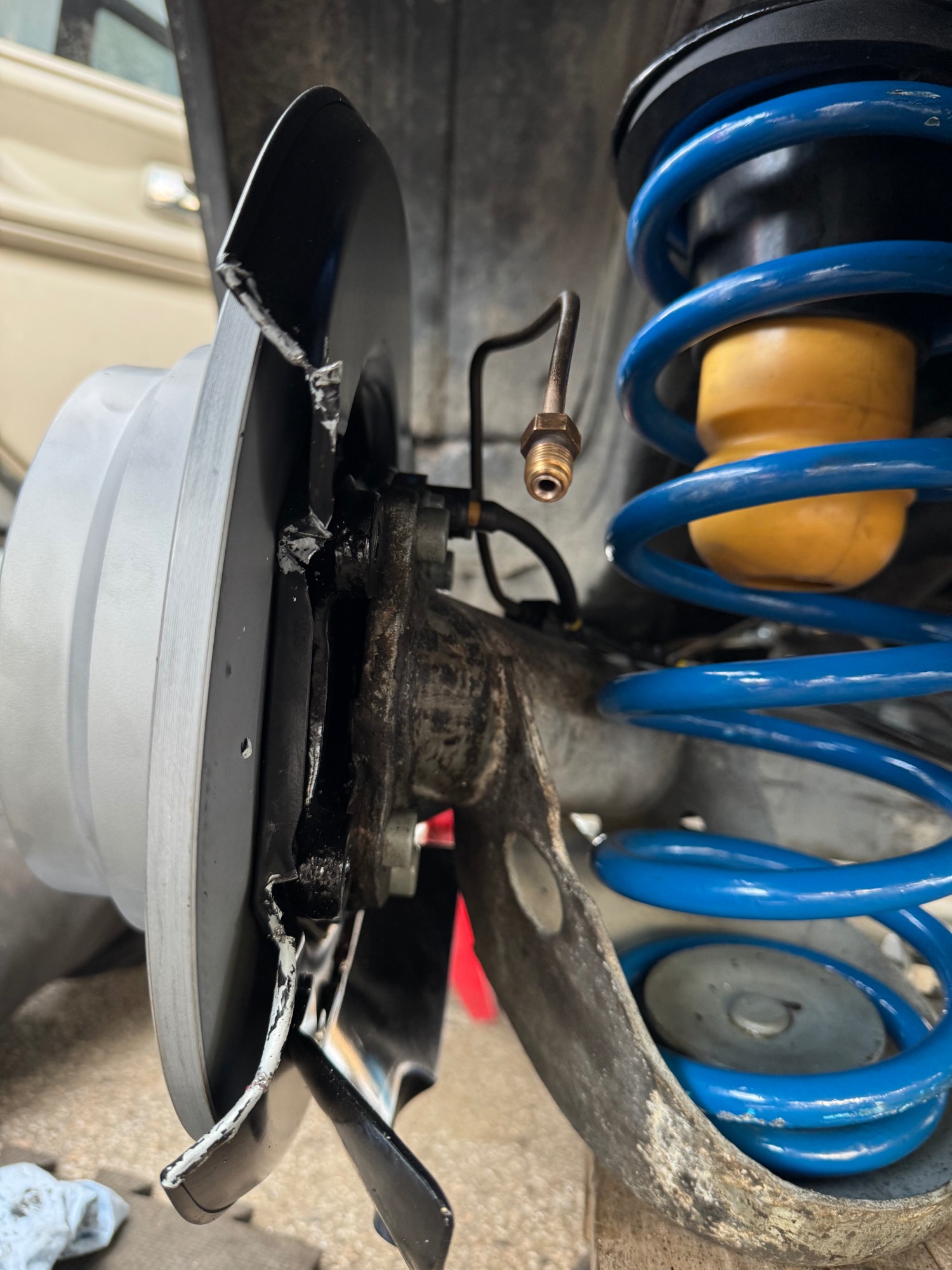 Cheap dust shield on the driver side needed to be cut and bent back to allow more room for the caliper.