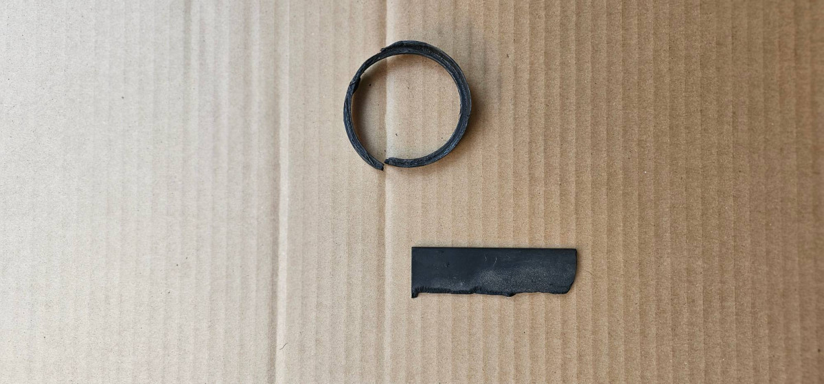 Plastic parts found in the TB area. Ring from the tensioner and flat plastic from the fixed TB cover.  See 3rd photo with diagonal edge at "9 o'clock" position