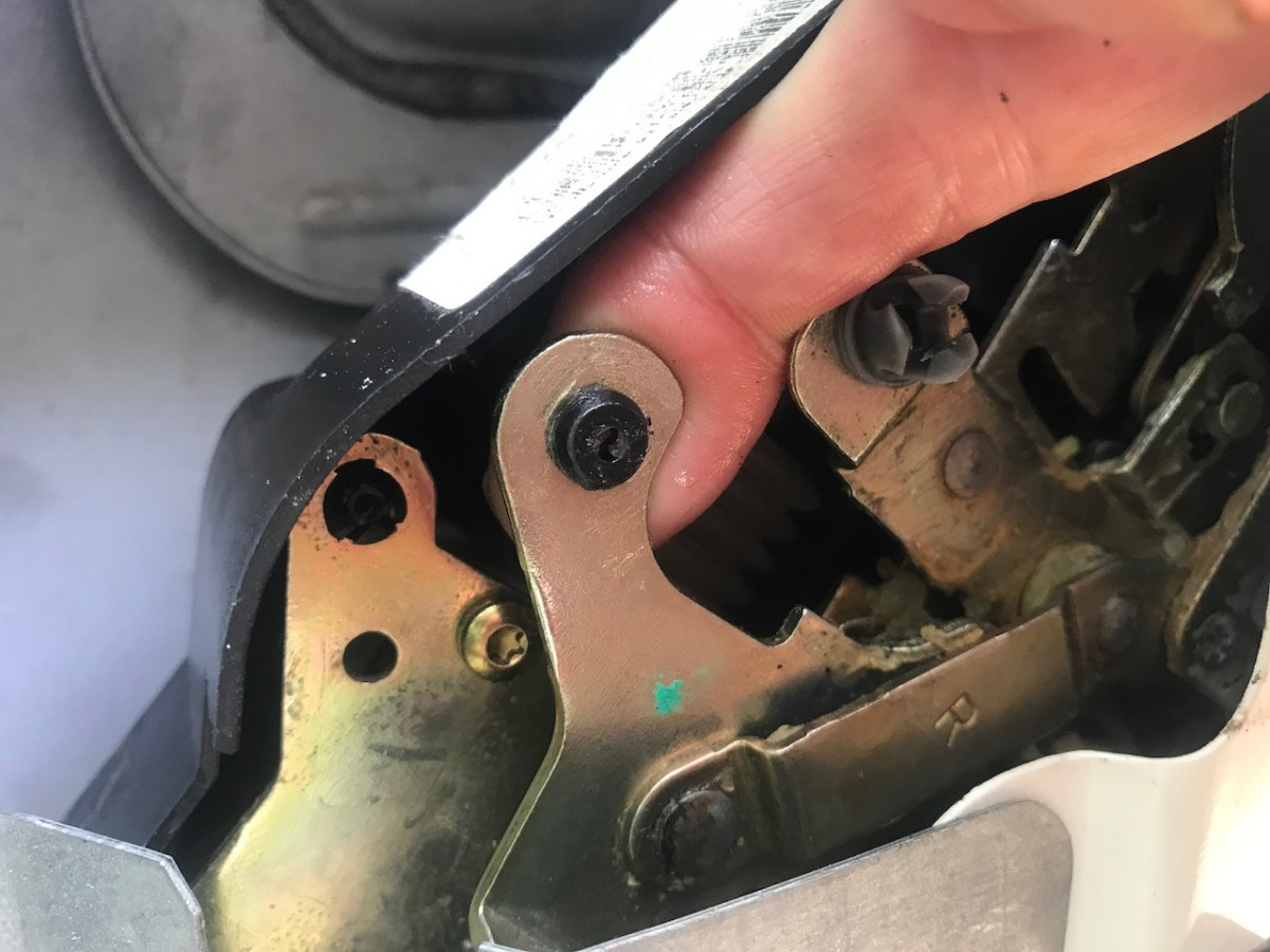 Pushing new grommet into position in hole on metal arm