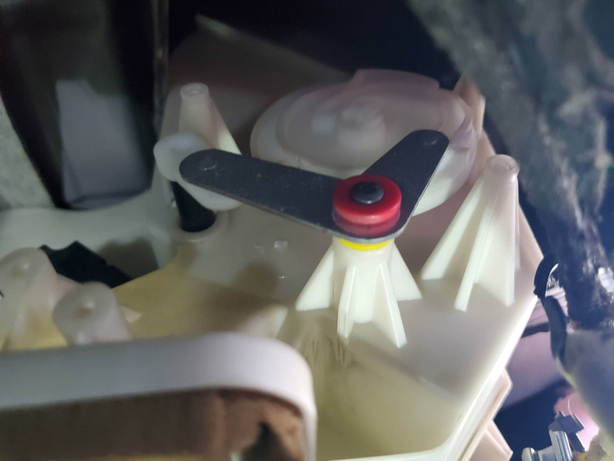 Motor removed.  Note 3 mounting points visible.  Motor shaft turns white scroll wheel, that moves lever, lever moves flap.