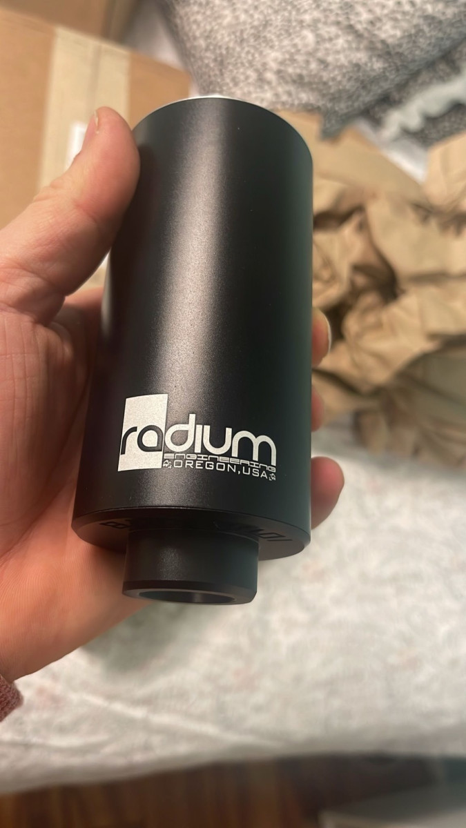 Radium high flow inline fuel filter w/built in check valve and 6micron glass mat filter media