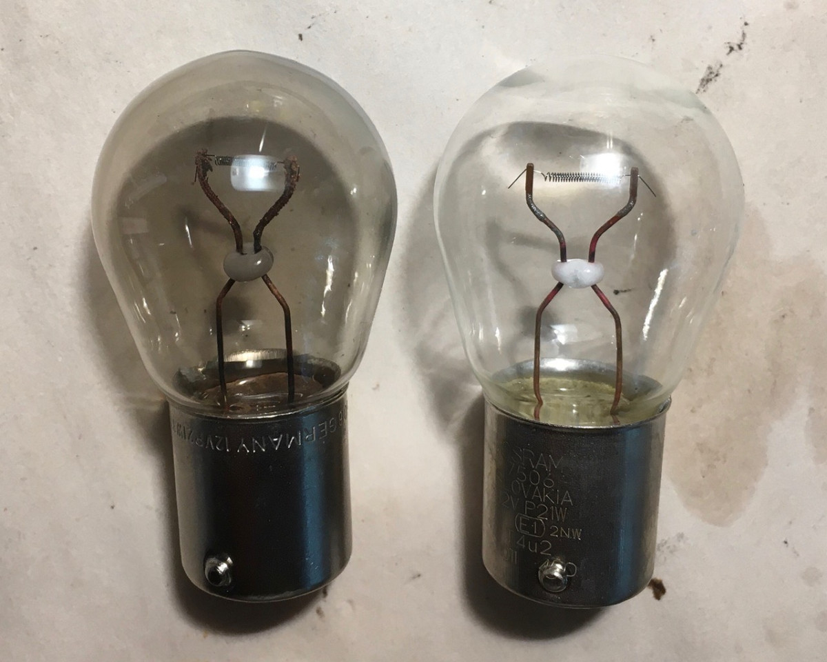 Old bulb on left with metal cloud on inside, and new bulb on right