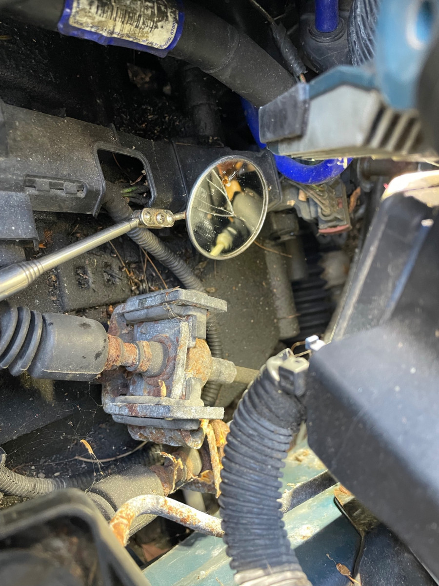 You can just see the clip in the mirror buried under the booster and fuse boxes, If yoiur spatials are good you can get that with a pick but they do rust in place....in which case...