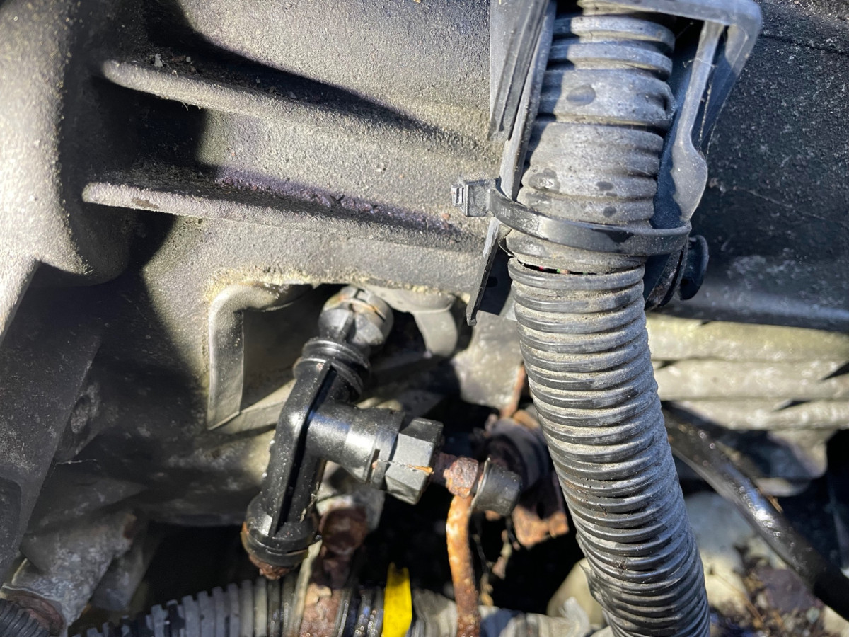 I invented and patented this trick, then read about it in the Volvo service instructions. My fame lasted 2 hours. Note the rubber bellows in scrunched into the tranmission housing just a bit, but the clip is easily accessed.
