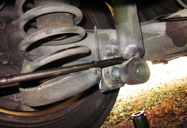 *Picture of screwdriver being used as a prybar popping off the shock