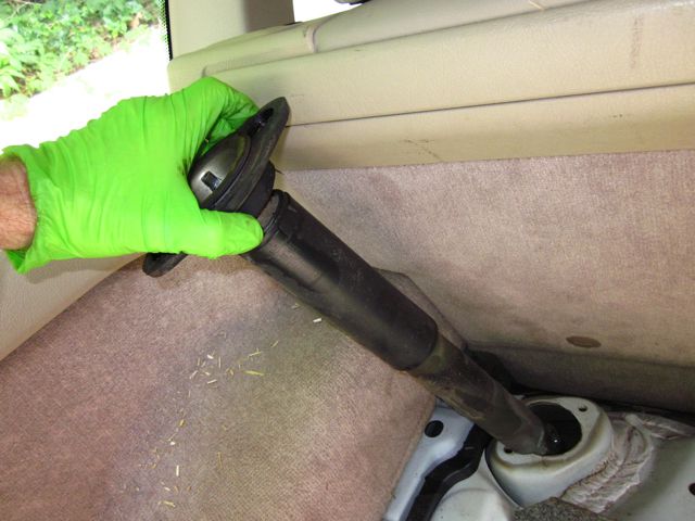 Old shock and mount being lifted out of car.