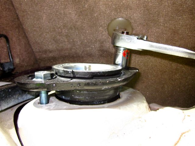 Mount being attached to car with new mounting bolts.