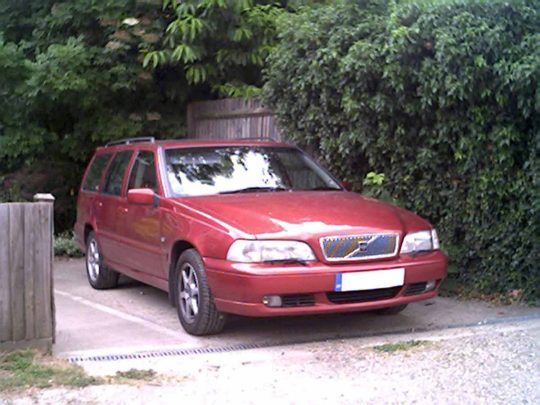 1998 Volvo V70 in garnet red. Six years old at time of picture, 105,000 miles on the clock. It might be able to use a 2000 V70R dual muffler.